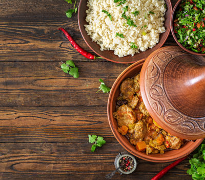 Traditional Tajine Dishes, Couscous And Fresh Salad On Rustic